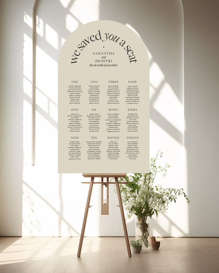 Arch Seating Chart with Flowers and Easel