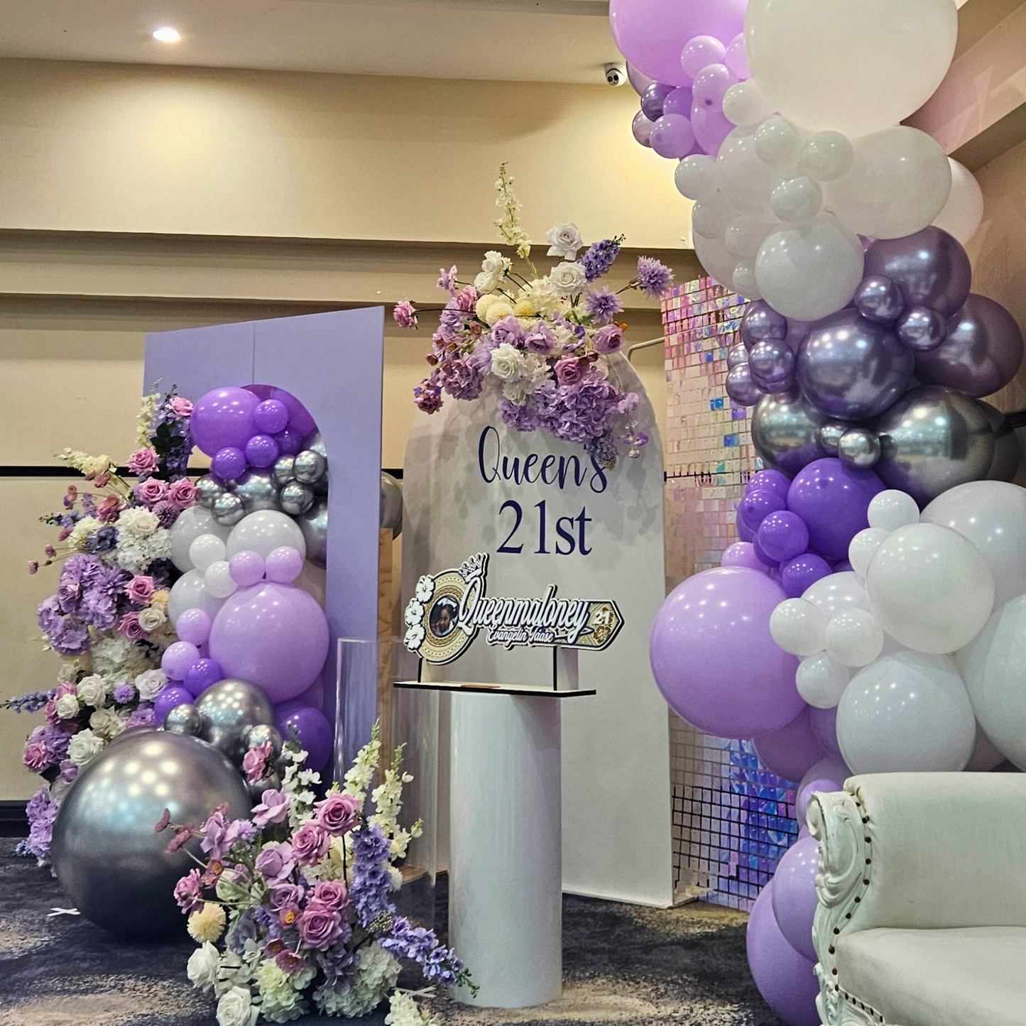Purple and silver themed backdrop with shimmer wall. Large balloon installation with 3 floral arrangements. Prop hire, Prop hiring, Prop hire, event stylists Brisbane, brisbane event styling, brisbane event styling, event stylist Brisbane, Brisbane Wedding, Gold Coast Wedding, Floral Styling, Lush & Lavish Events, Brisbane Corporate Styling, Gold Coast Corporate Styling, Brisbane Brand Activation