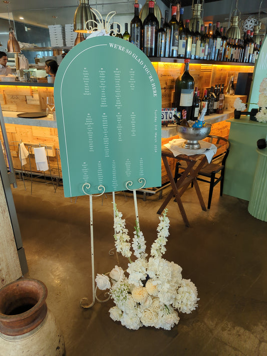 Arch Seating Chart with Flowers and Easel