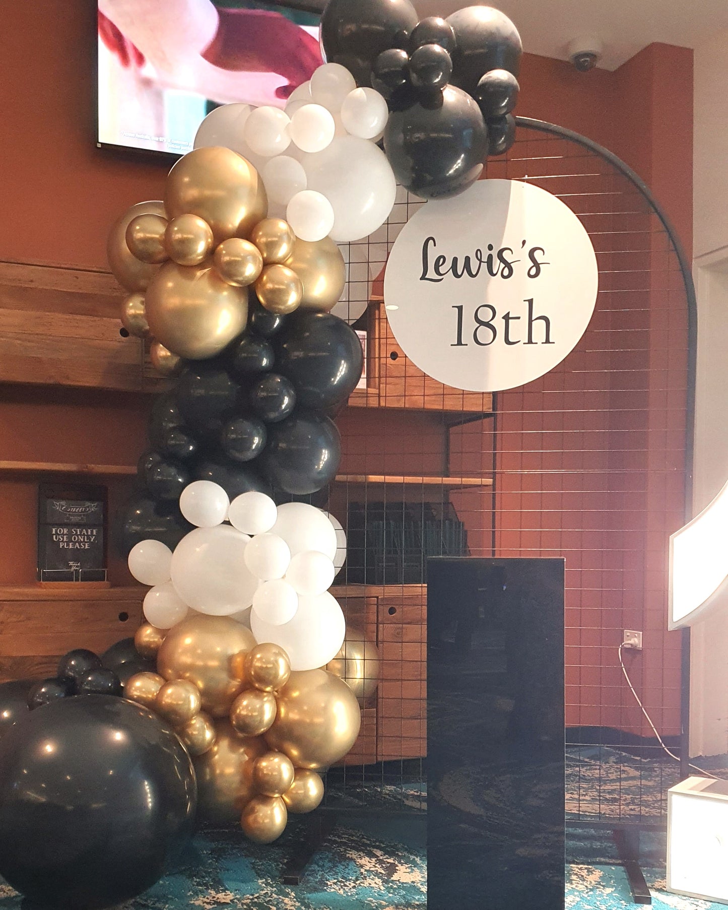Black, white, and gold balloon arch with a sign that reads "Lewis's 18th." Prop hire, Prop hiring, Prop hire, event stylists Brisbane, brisbane event styling, brisbane event styling, event stylist Brisbane, Brisbane Wedding, Gold Coast Wedding, Floral Styling, Lush & Lavish Events, Brisbane Tablescape, Gold Coast Tablescapes, Brisbane Candle Hire