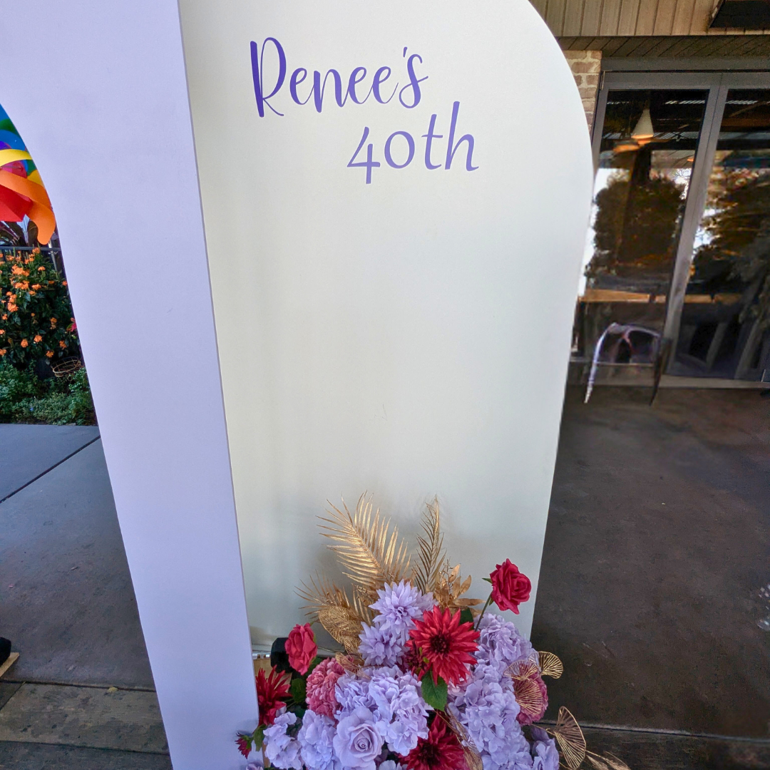 Floral backdrop in purple and red with signage reading "Renee's 40th". Prop hire, Prop hiring, Prop hire, event stylists Brisbane, brisbane event styling, brisbane event styling, event stylist Brisbane, Brisbane Wedding, Gold Coast Wedding, Floral Styling, Lush & Lavish Events, Brisbane Corporate Styling, Gold Coast Corporate Styling, Brisbane Brand Activation, Gold Coast Tablescapes, Brisbane Candle Hire