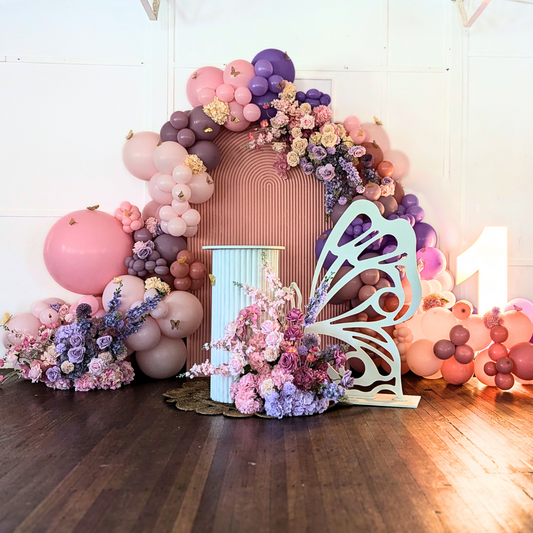 Floral and balloon backdrop in pinks and purples with gold butterfly's and a larger white butterfly. Prop hire, Prop hiring, Prop hire, event stylists Brisbane, brisbane event styling, brisbane event styling, event stylist Brisbane, Brisbane Wedding, Gold Coast Wedding, Floral Styling, Lush & Lavish Events, Brisbane Corporate Styling, Gold Coast Corporate Styling, Brisbane Brand Activation, Gold Coast Tablescapes, Brisbane Candle Hire