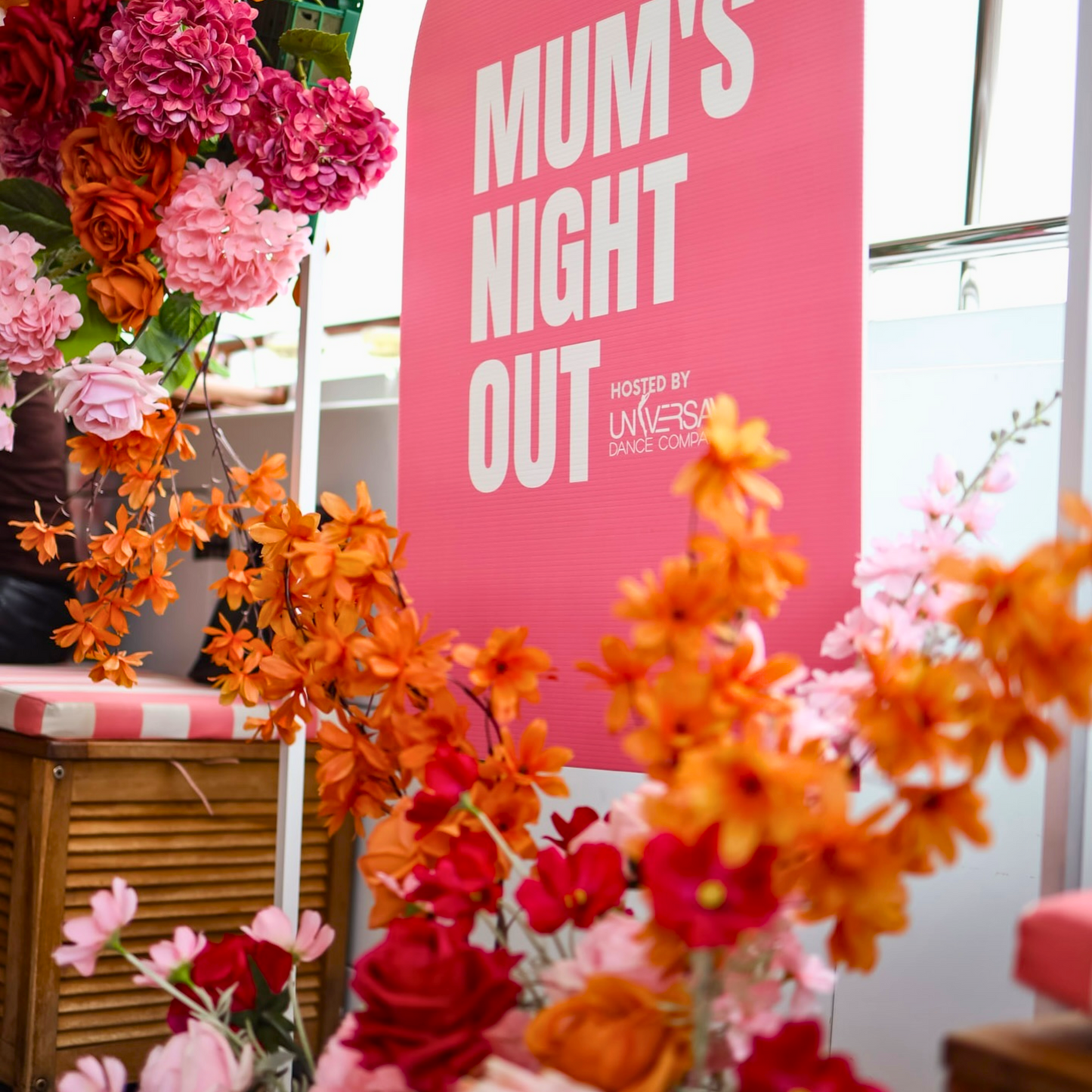 Pink 'MUM’S NIGHT OUT' sign surrounded by vibrant flowers on a boat deck. Prop hire, Prop hiring, Prop hire, event stylists Brisbane, brisbane event styling, brisbane event styling, event stylist Brisbane, Brisbane Wedding, Gold Coast Wedding, Floral Styling, Lush & Lavish Events, Brisbane Tablescape, Gold Coast Tablescapes, Brisbane Candle Hire