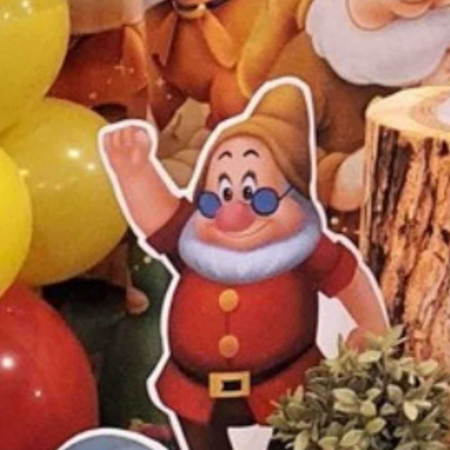 Cutout of a dwarf character from Snow White, positioned in front of colorful balloons with a blurred background, ideal for themed parties or events. Prop hire, Prop hiring, Prop hire, event stylists Brisbane, brisbane event styling, brisbane event styling, event stylist Brisbane, Brisbane Wedding, Gold Coast Wedding, Floral Styling, Lush & Lavish Events, Brisbane Tablescape, Gold Coast Tablescapes, Brisbane Candle Hire