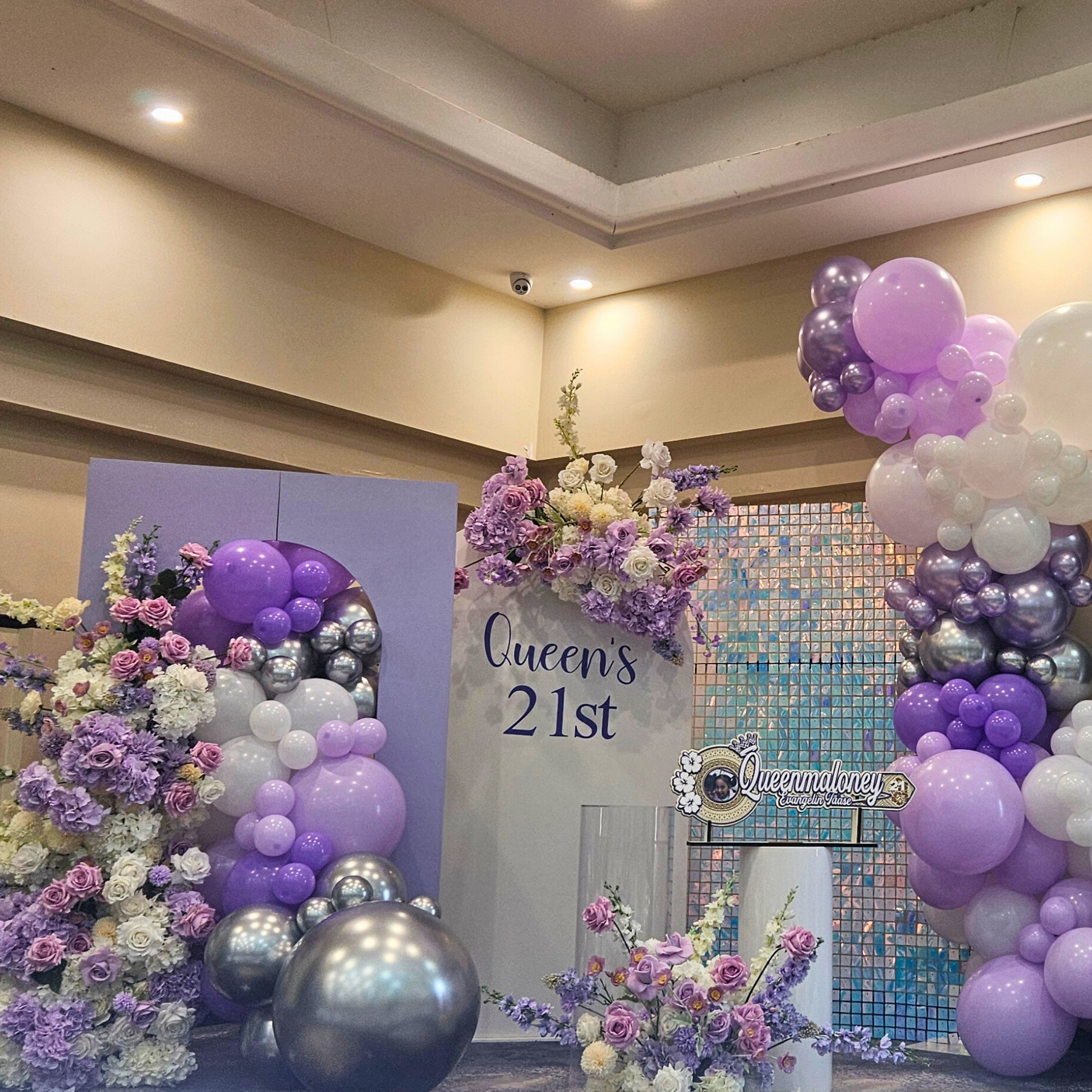 Purple and silver themed backdrop with shimmer wall. Large balloon installation with 3 floral arrangements. Prop hire, Prop hiring, Prop hire, event stylists Brisbane, brisbane event styling, brisbane event styling, event stylist Brisbane, Brisbane Wedding, Gold Coast Wedding, Floral Styling, Lush & Lavish Events, Brisbane Corporate Styling, Gold Coast Corporate Styling, Brisbane Brand Activation
