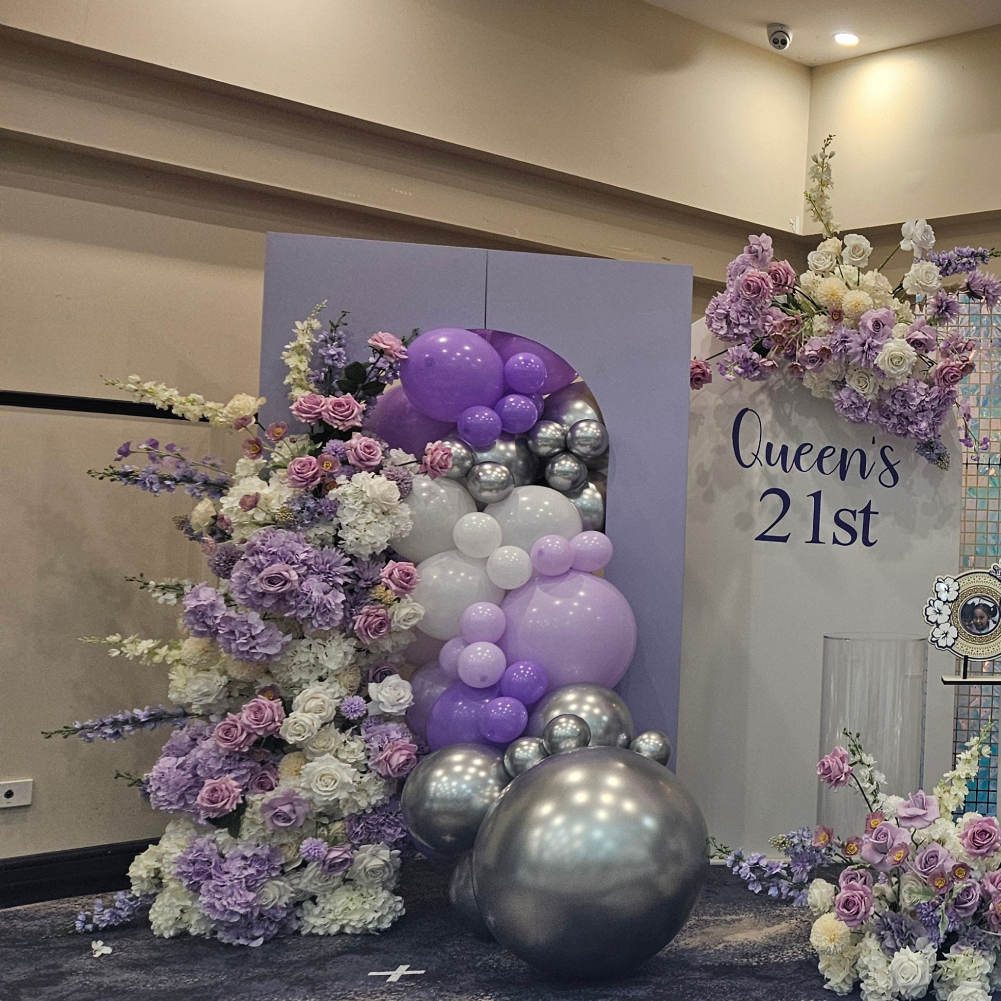Purple and silver themed backdrop with shimmer wall. Large balloon installation with 3 floral arrangements. Prop hire, Prop hiring, Prop hire, event stylists Brisbane, brisbane event styling, brisbane event styling, event stylist Brisbane, Brisbane Wedding, Gold Coast Wedding, Floral Styling, Lush & Lavish Events, Brisbane Corporate Styling, Gold Coast Corporate Styling, Brisbane Brand Activation