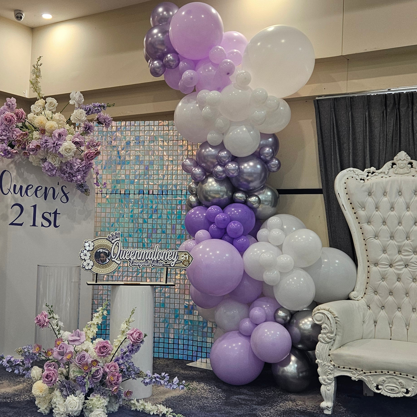 Purple and silver themed backdrop with shimmer wall. Large balloon installation with 3 floral arrangements. Prop hire, Prop hiring, Prop hire, event stylists Brisbane, brisbane event styling, brisbane event styling, event stylist Brisbane, Brisbane Wedding, Gold Coast Wedding, Floral Styling, Lush & Lavish Events, Brisbane Corporate Styling, Gold Coast Corporate Styling, Brisbane Brand Activation