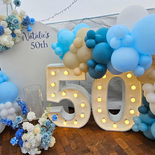 Blue and white balloon and floral backdrop for a 50th birthday. Large 50 LED numbers and a cake plinth. Prop hire, Prop hiring, Prop hire, event stylists Brisbane, brisbane event styling, brisbane event styling, event stylist Brisbane, Brisbane Wedding, Gold Coast Wedding, Floral Styling, Lush & Lavish Events, Brisbane Corporate Styling, Gold Coast Corporate Styling, Brisbane Brand Activation, Gold Coast Tablescapes, Brisbane Candle Hire