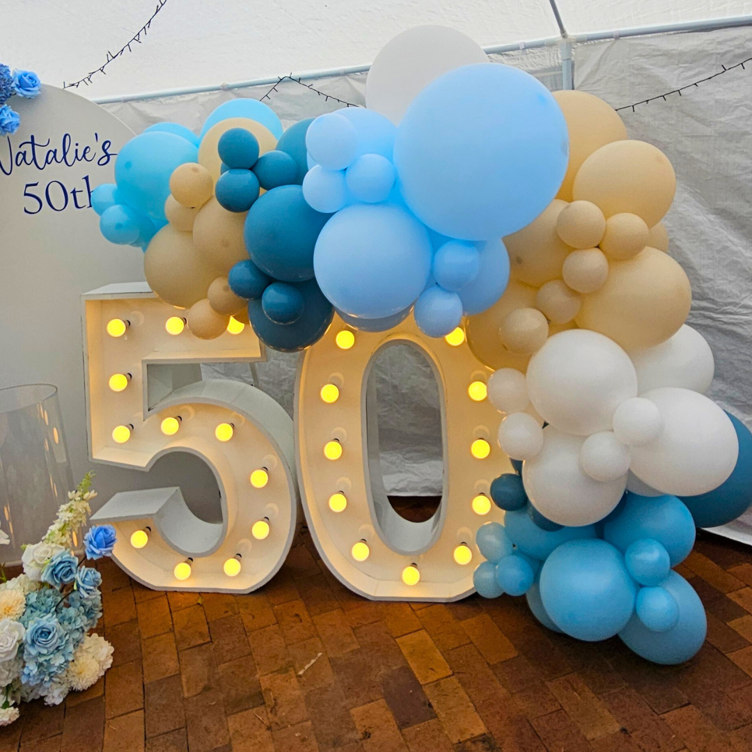 Blue and white balloon and floral backdrop for a 50th birthday. Large 50 LED numbers and a cake plinth. Prop hire, Prop hiring, Prop hire, event stylists Brisbane, brisbane event styling, brisbane event styling, event stylist Brisbane, Brisbane Wedding, Gold Coast Wedding, Floral Styling, Lush & Lavish Events, Brisbane Corporate Styling, Gold Coast Corporate Styling, Brisbane Brand Activation, Gold Coast Tablescapes, Brisbane Candle Hire
