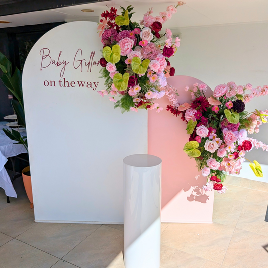 Burgundy and green baby shower floral backdrop featuring elegant artificial flowers, lush greenery and a stylish celebration design. Perfect for luxury baby showers, gender reveals, welcome baby events and event styling in Brisbane, Gold Coast and South East Queensland.
