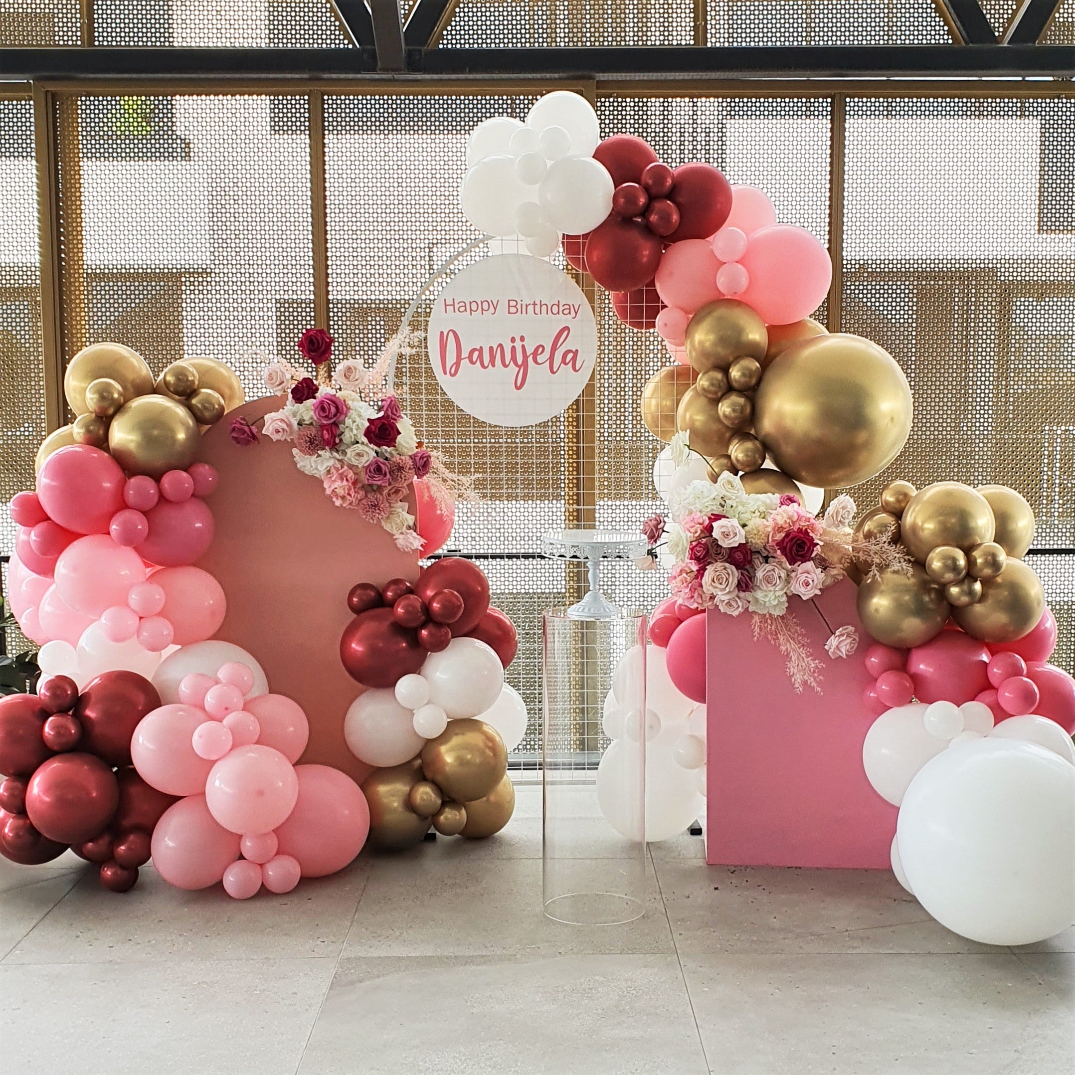 Pink, white, and gold balloon arch with a pink and gold backdrop and a sign that says "Happy Birthday Danijela" Prop hire, Prop hiring, Prop hire, event stylists Brisbane, brisbane event styling, brisbane event styling, event stylist Brisbane, Brisbane Wedding, Gold Coast Wedding, Floral Styling, Lush & Lavish Events, Brisbane Tablescape, Gold Coast Tablescapes, Brisbane Candle Hire