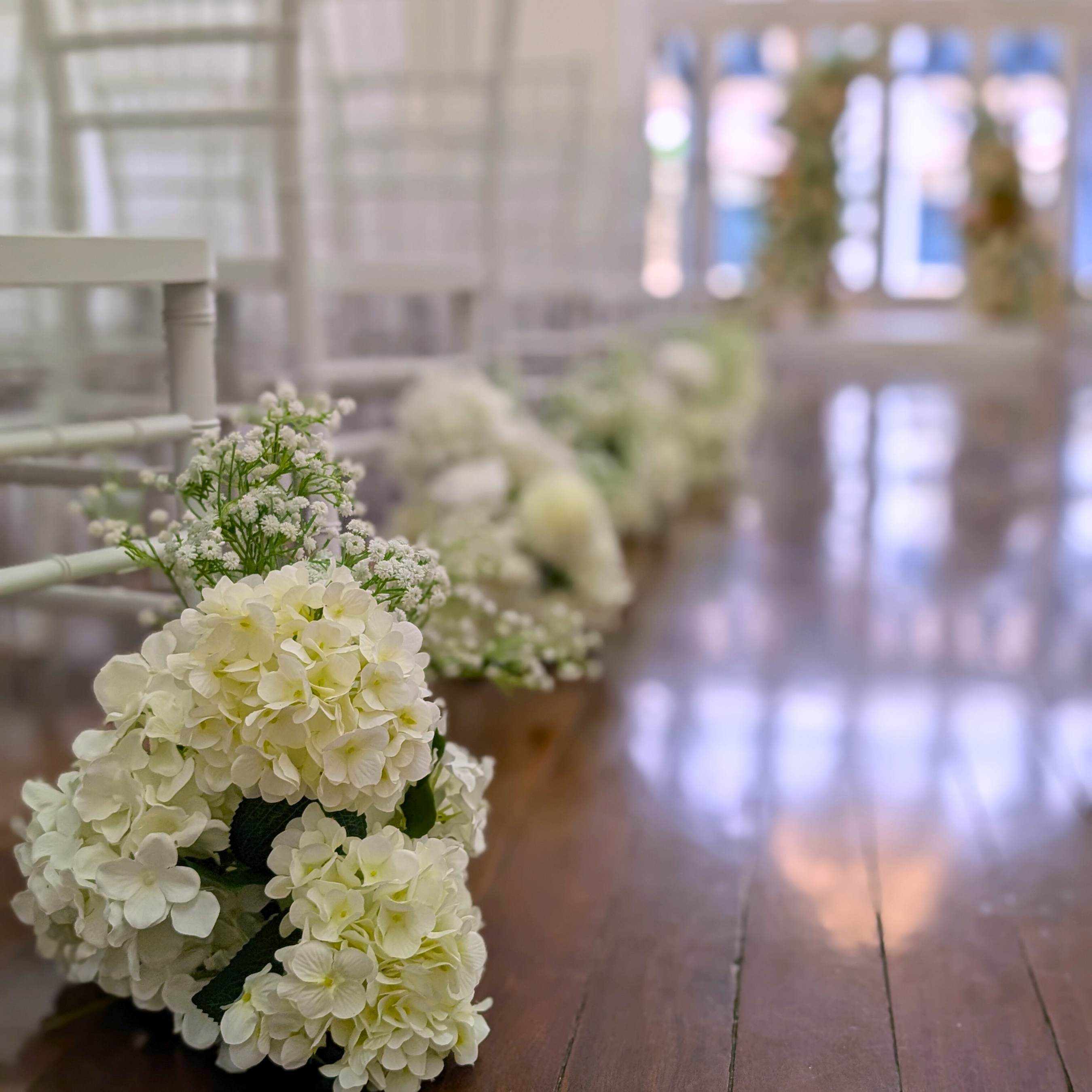 Aisle markers on a wooden floor with chairs in the background. the little laneway wedding styling, the little laneway brisbane wedding venue styling, wedme brisbane wedding vendor, wedme co brisbane wedding trail, brisbane wedding styling, brisbane wedding stylist, luxury wedding styling brisbane, wedding ceremony styling brisbane, wedding reception styling brisbane, wedding altar styling brisbane, bridal table styling ideas, guest table wedding styling, wedding aisle styling ideas.