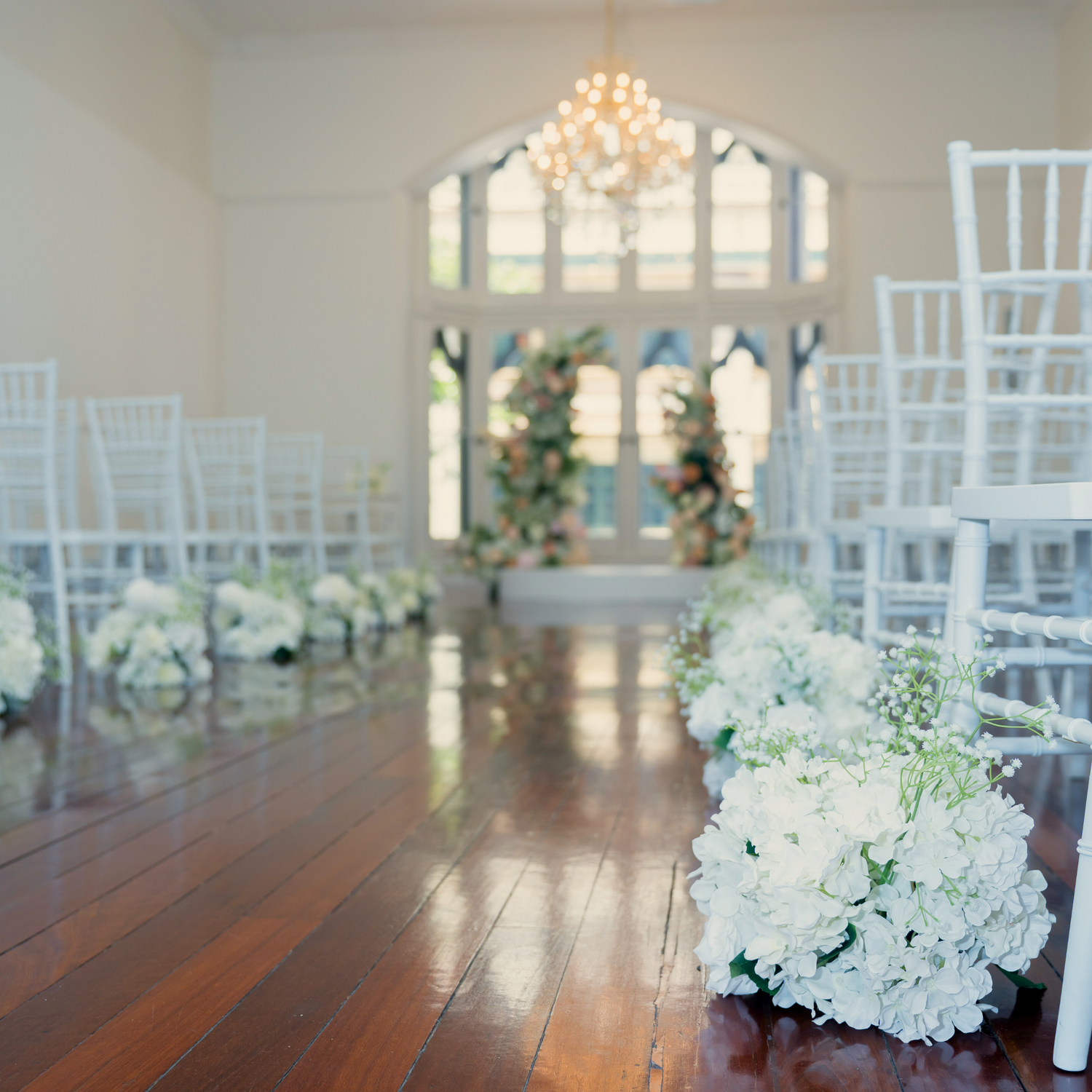 Decorated wedding aisle with white aisle markers and floral arrangements in a chapel setting. the little laneway wedding styling, the little laneway brisbane wedding venue styling, wedme brisbane wedding vendor, wedme co brisbane wedding trail, brisbane wedding styling, brisbane wedding stylist, luxury wedding styling brisbane, wedding ceremony styling brisbane, wedding reception styling brisbane, wedding altar styling brisbane, bridal table styling ideas, guest table wedding styling, wedding aisle styling 