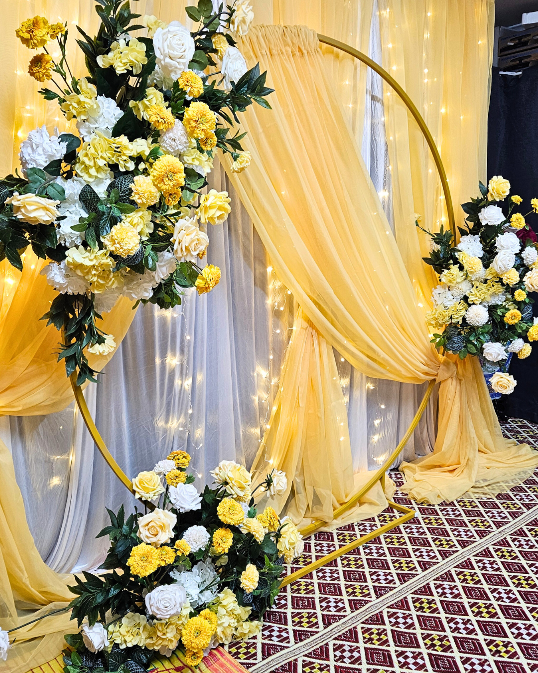 Yellow draped curtain backdrop with floral arrangements. Prop hire, Prop hiring, Prop hire, event stylists Brisbane, brisbane event styling, brisbane event styling, event stylist Brisbane, Brisbane Wedding, Gold Coast Wedding, Floral Styling, Lush & Lavish Events, Brisbane Corporate Styling, Gold Coast Corporate Styling, Brisbane Brand Activation, Gold Coast Tablescapes, Brisbane Candle Hire