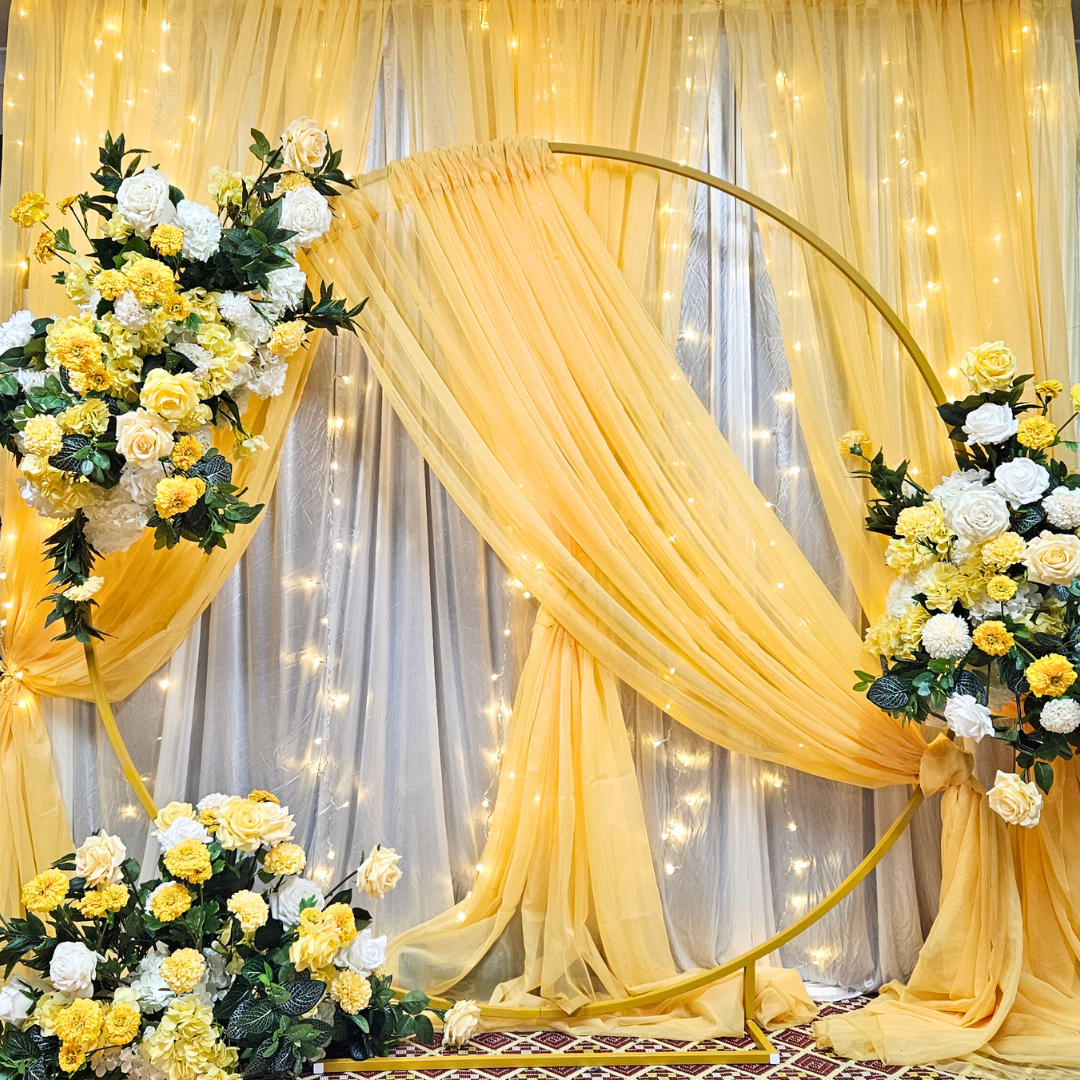 Yellow draped curtain backdrop with floral arrangements. Prop hire, Prop hiring, Prop hire, event stylists Brisbane, brisbane event styling, brisbane event styling, event stylist Brisbane, Brisbane Wedding, Gold Coast Wedding, Floral Styling, Lush & Lavish Events, Brisbane Corporate Styling, Gold Coast Corporate Styling, Brisbane Brand Activation, Gold Coast Tablescapes, Brisbane Candle Hire
