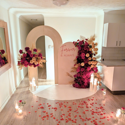 Romantic proposal backdrop with candles, elegant floral styling and a luxury setup designed for marriage proposals. A beautiful surprise proposal decoration for men planning a memorable proposal for their girlfriend, creating an intimate and romantic engagement moment in Brisbane, Gold Coast and South East Queensland.