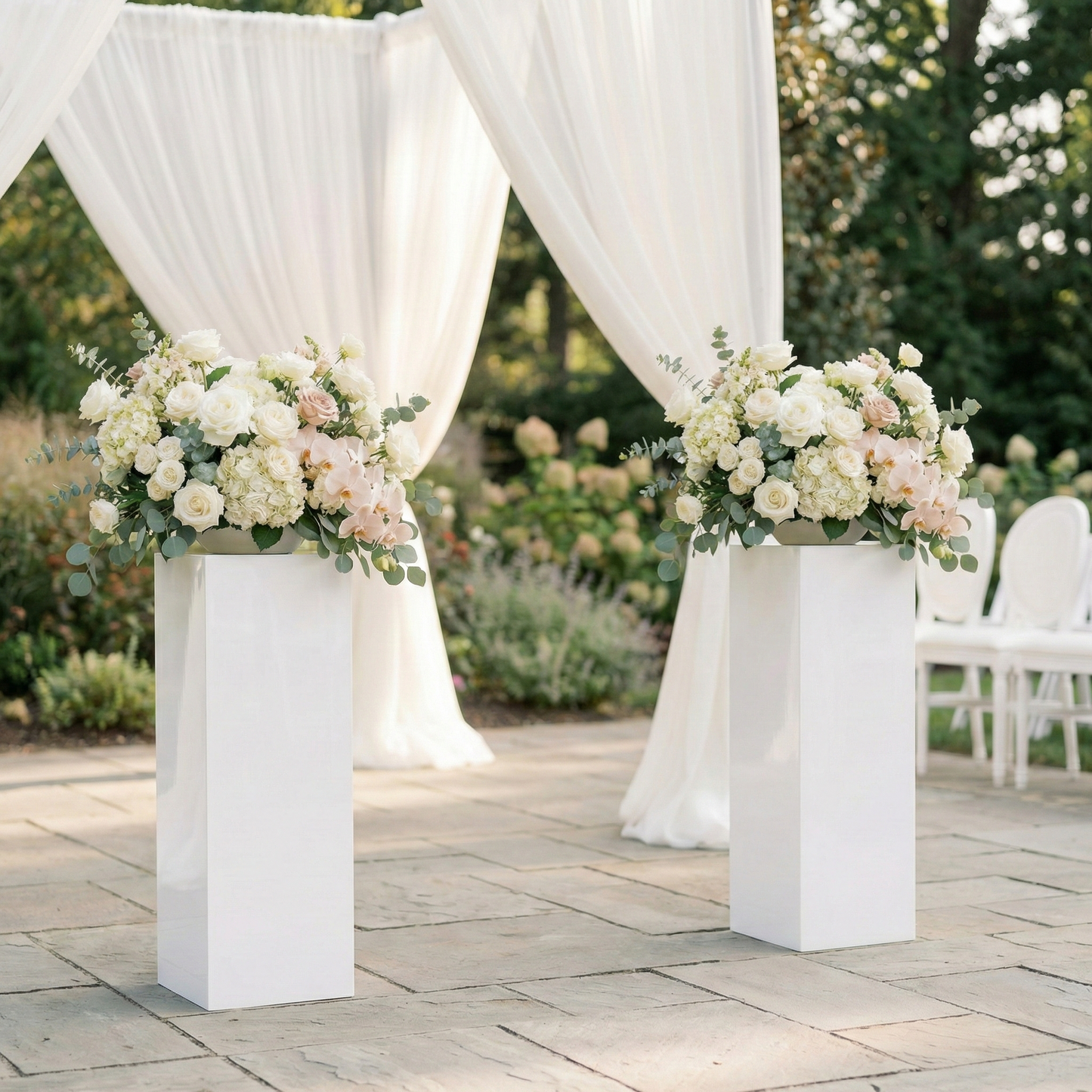 Pair of tall gloss white acrylic plinths for hire featuring custom lush floral arrangements of white roses, hydrangeas, and blush orchids. Set up as luxury wedding ceremony aisle décor with a white drapery arbor background for Brisbane event styling.

acrylic plinth hire, wedding ceremony plinths, floral pedestal stand, black acrylic plinths, white acrylic plinths, event prop hire, luxury wedding decor, ceremony styling, floral arrangement hire, Brisbane event hire, Gold Coast party hire, wedding aisle deco