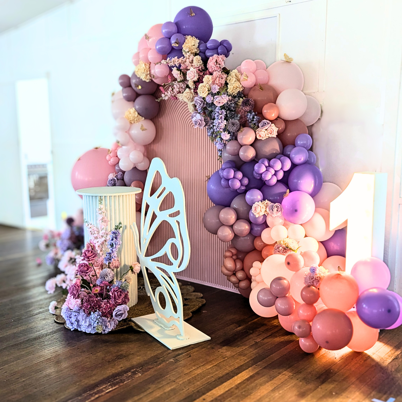 Floral and balloon backdrop in pinks and purples with gold butterfly's and a larger white butterfly. Prop hire, Prop hiring, Prop hire, event stylists Brisbane, brisbane event styling, brisbane event styling, event stylist Brisbane, Brisbane Wedding, Gold Coast Wedding, Floral Styling, Lush & Lavish Events, Brisbane Corporate Styling, Gold Coast Corporate Styling, Brisbane Brand Activation, Gold Coast Tablescapes, Brisbane Candle Hire
