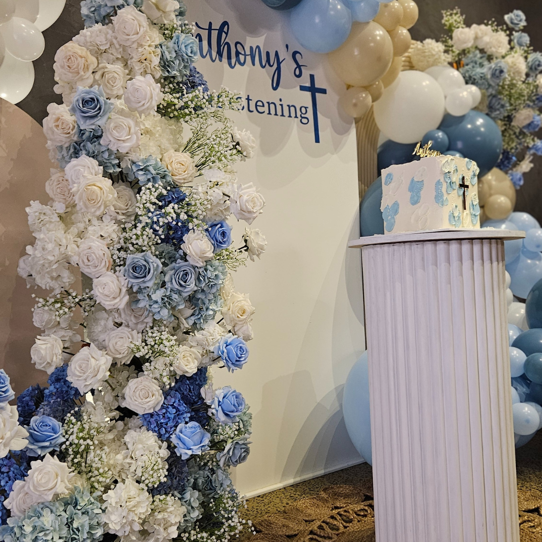 blue white floral and balloon backdrop woth wording "Anthony's Christening" . PErsonalised menus with guest name on, baby breath bud vases and white floral domes. Personalised custom seating chart and floral arrangement. Prop hire, Prop hiring, Prop hire, event stylists Brisbane, brisbane event styling, brisbane event styling, event stylist Brisbane, Brisbane Wedding, Gold Coast Wedding, Floral Styling, Lush & Lavish Events, Brisbane Corporate Styling, Gold Coast Tablescapes, Brisbane Candle Hire