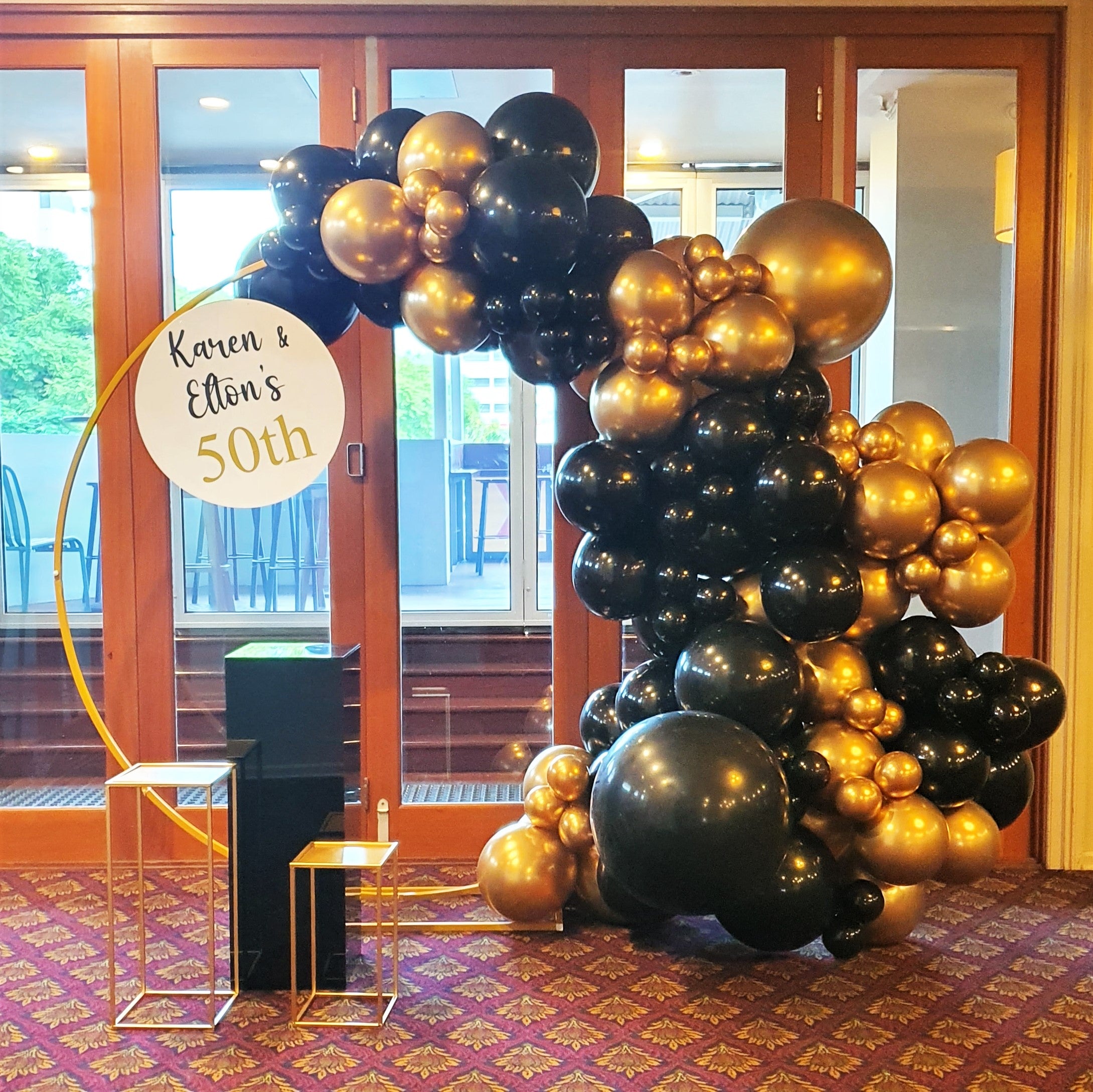 Black and gold round balloon arch at venue entrance for milestone celebrations. Prop hire, Prop hiring, Prop hire, event stylists Brisbane, brisbane event styling, brisbane event styling, event stylist Brisbane, Brisbane Wedding, Gold Coast Wedding, Floral Styling, Lush & Lavish Events, Brisbane Tablescape, Gold Coast Tablescapes, Brisbane Candle Hire