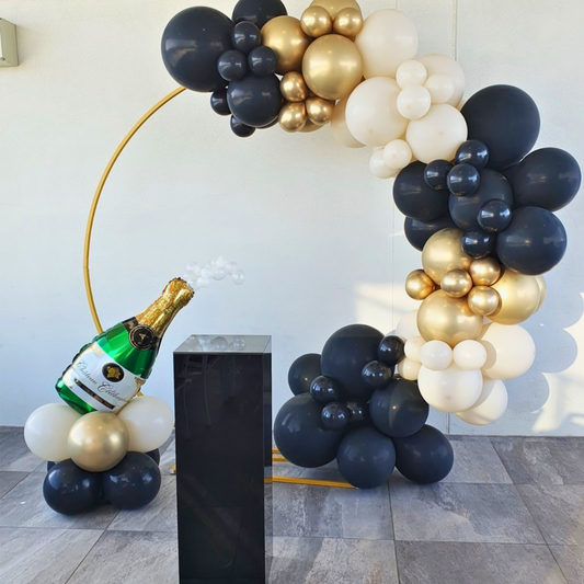 Black, white, and gold balloon arch with a black plinth and a champagne bottle balloon bouquet. Prop hire, Prop hiring, Prop hire, event stylists Brisbane, brisbane event styling, brisbane event styling, event stylist Brisbane, Brisbane Wedding, Gold Coast Wedding, Floral Styling, Lush & Lavish Events, Brisbane Tablescape, Gold Coast Tablescapes, Brisbane Candle Hire