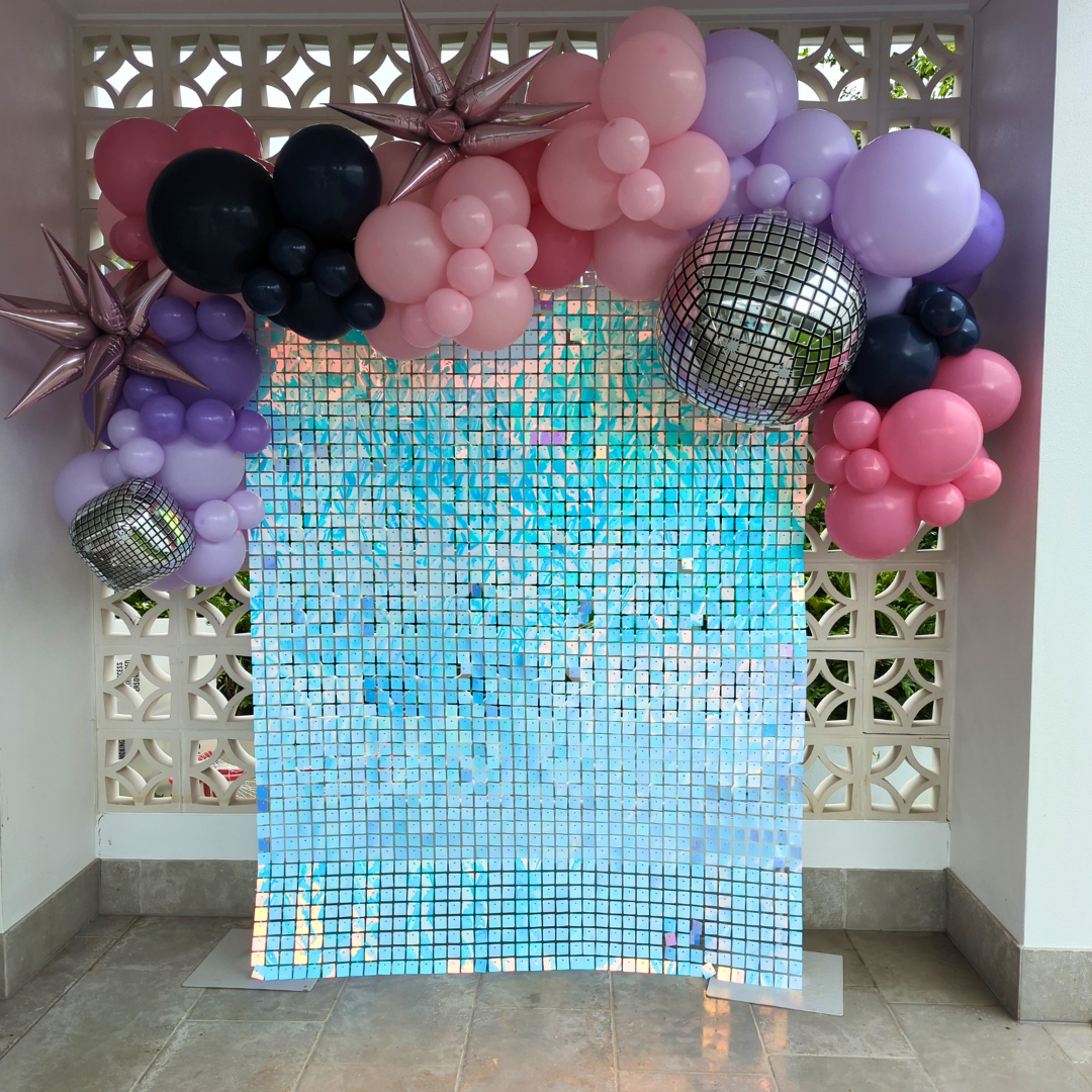 An Iridescent shimmer wall with a balloon garland in pinks, purples and navy with disco ball balloons. Prop hire, Prop hiring, Prop hire, event stylists Brisbane, brisbane event styling, brisbane event styling, event stylist Brisbane, Brisbane Wedding, Gold Coast Wedding, Floral Styling, Lush & Lavish Events, Brisbane Corporate Styling, Gold Coast Corporate Styling, Brisbane Brand Activation, Gold Coast Tablescapes, Brisbane Candle Hire 