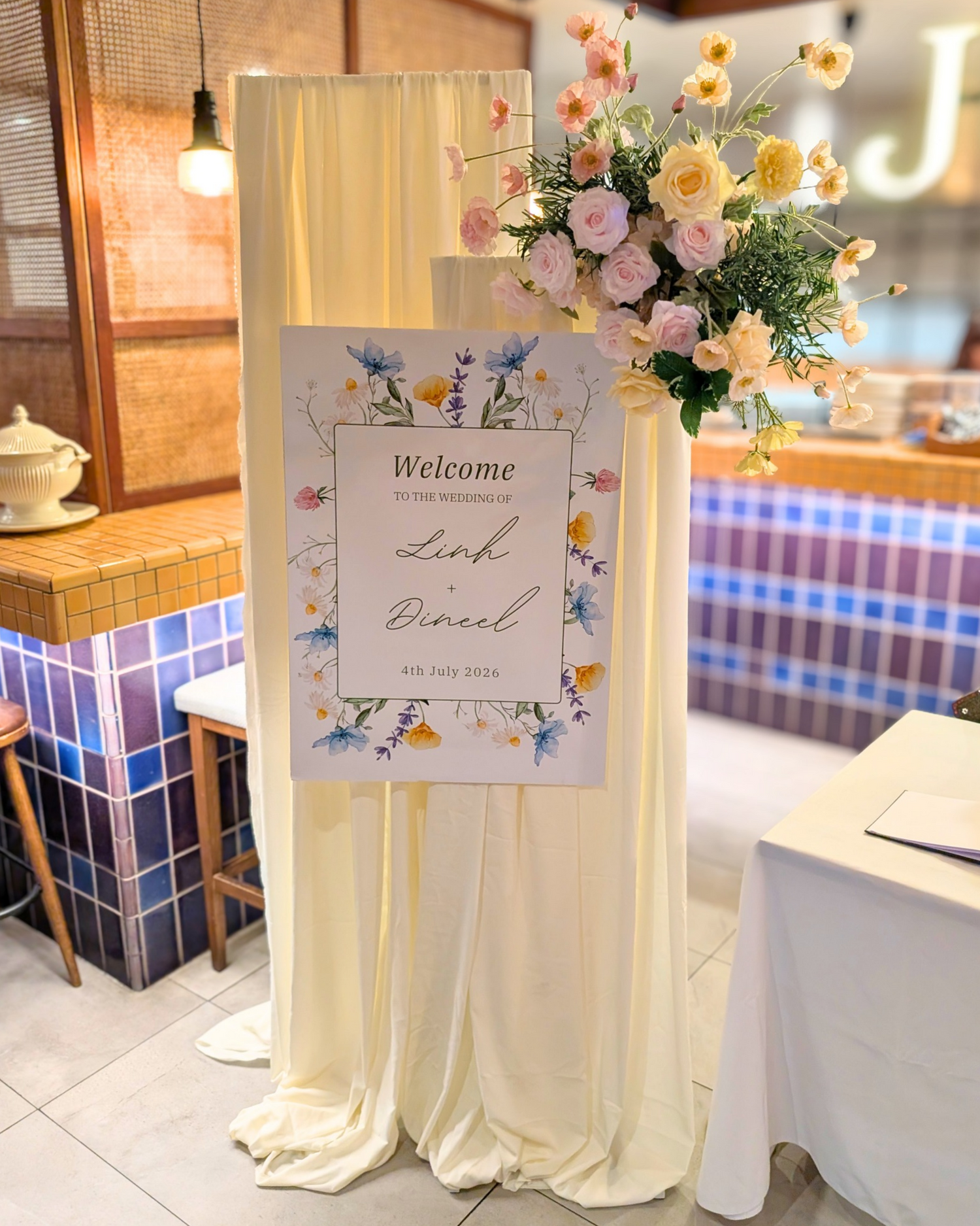 Luxury draped welcome sign hire featuring two elegant fabric-draped frames, a personalised welcome poster and a fresh floral arrangement, perfect for wedding receptions, engagement parties, baby showers, bridal showers and luxury event styling in Brisbane, Gold Coast and South East Queensland.