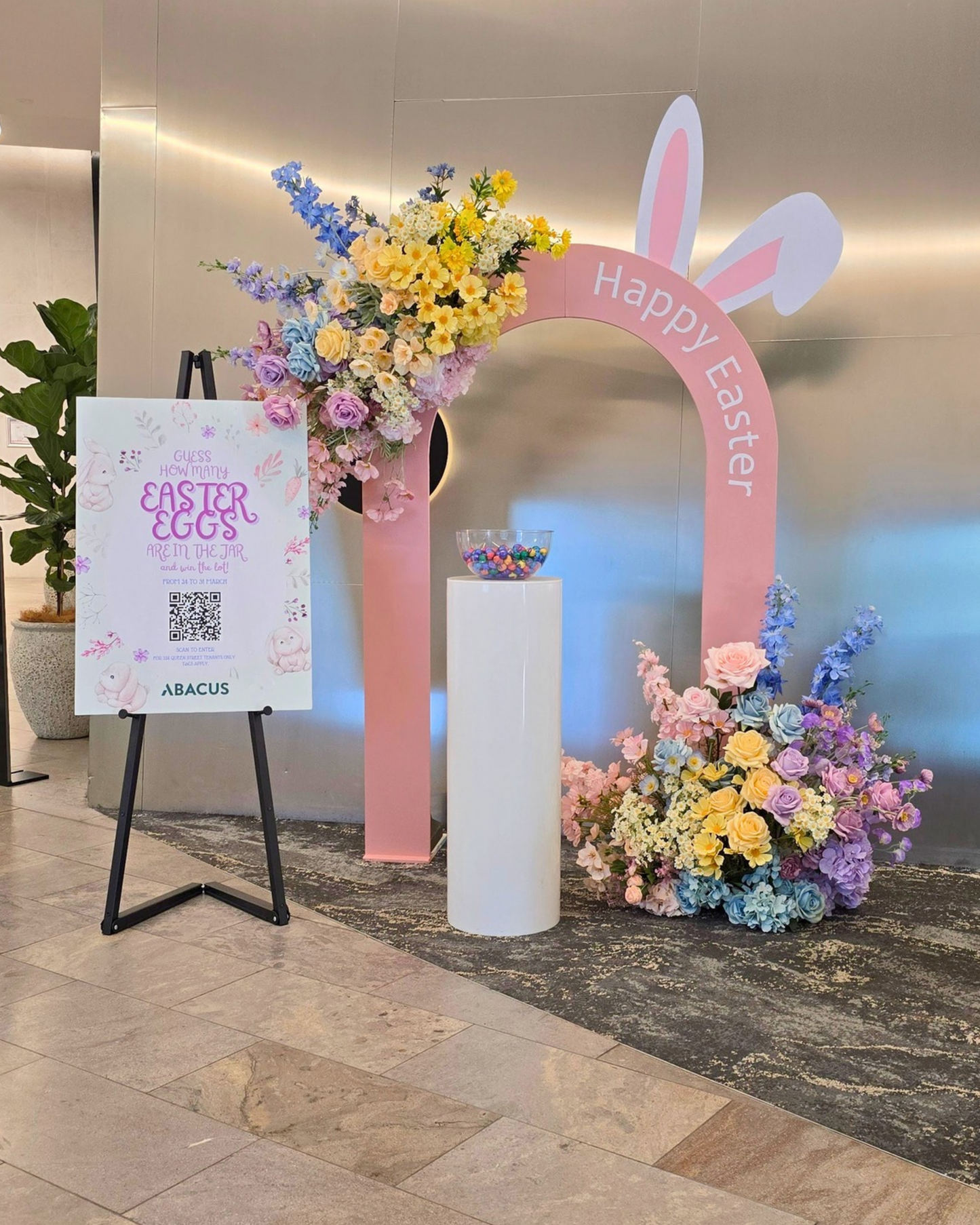 Easter themed brand activation backdrop featuring a hollow arch design with bunny ear cut out detail, oversized pastel floral arrangements and a stylish event display. Perfect for corporate Easter events, brand activations, retail installations, community events and promotional photo opportunities in Brisbane, Gold Coast and South East Queensland.