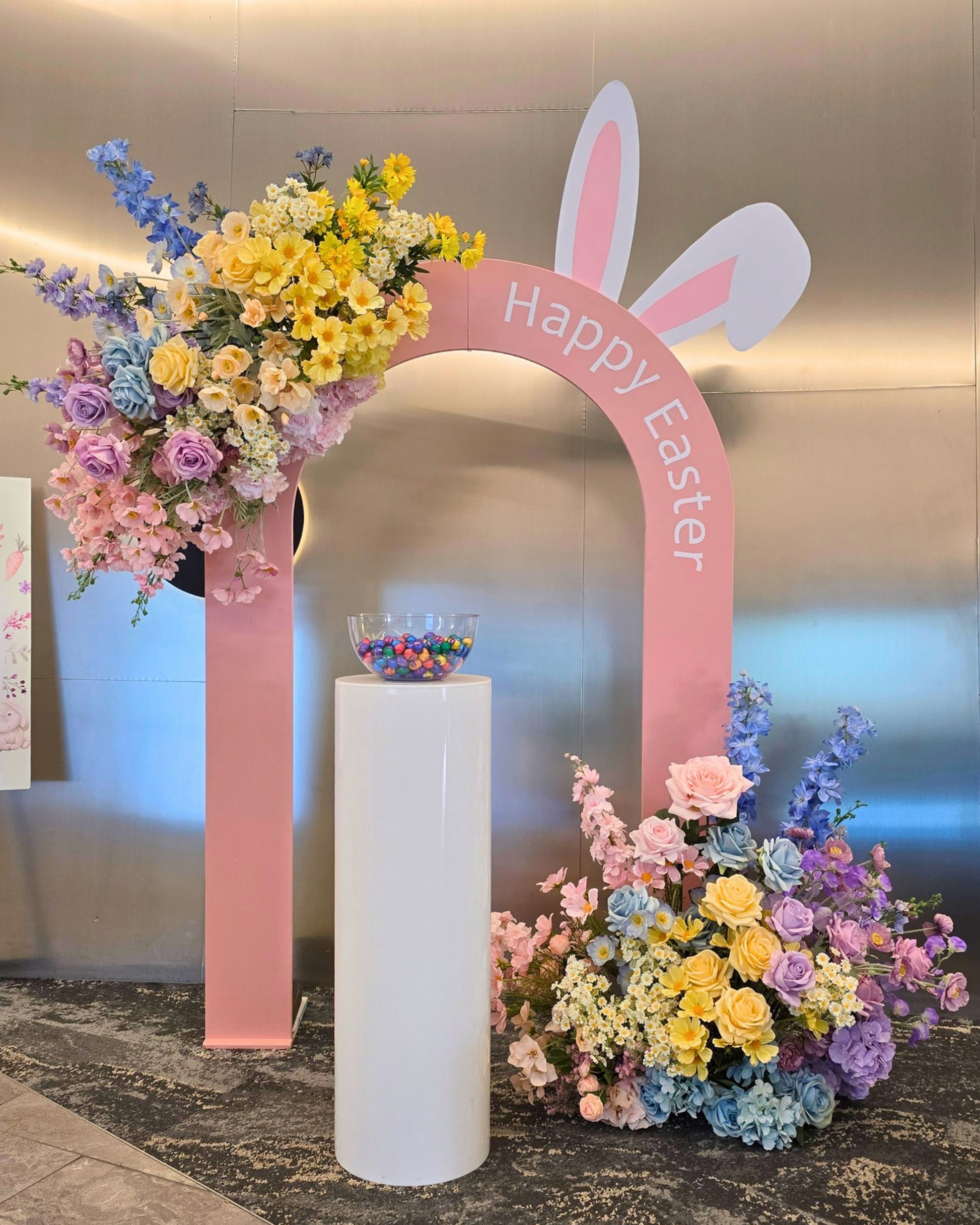 Easter themed brand activation backdrop featuring a hollow arch design with bunny ear cut out detail, oversized pastel floral arrangements and a stylish event display. Perfect for corporate Easter events, brand activations, retail installations, community events and promotional photo opportunities in Brisbane, Gold Coast and South East Queensland