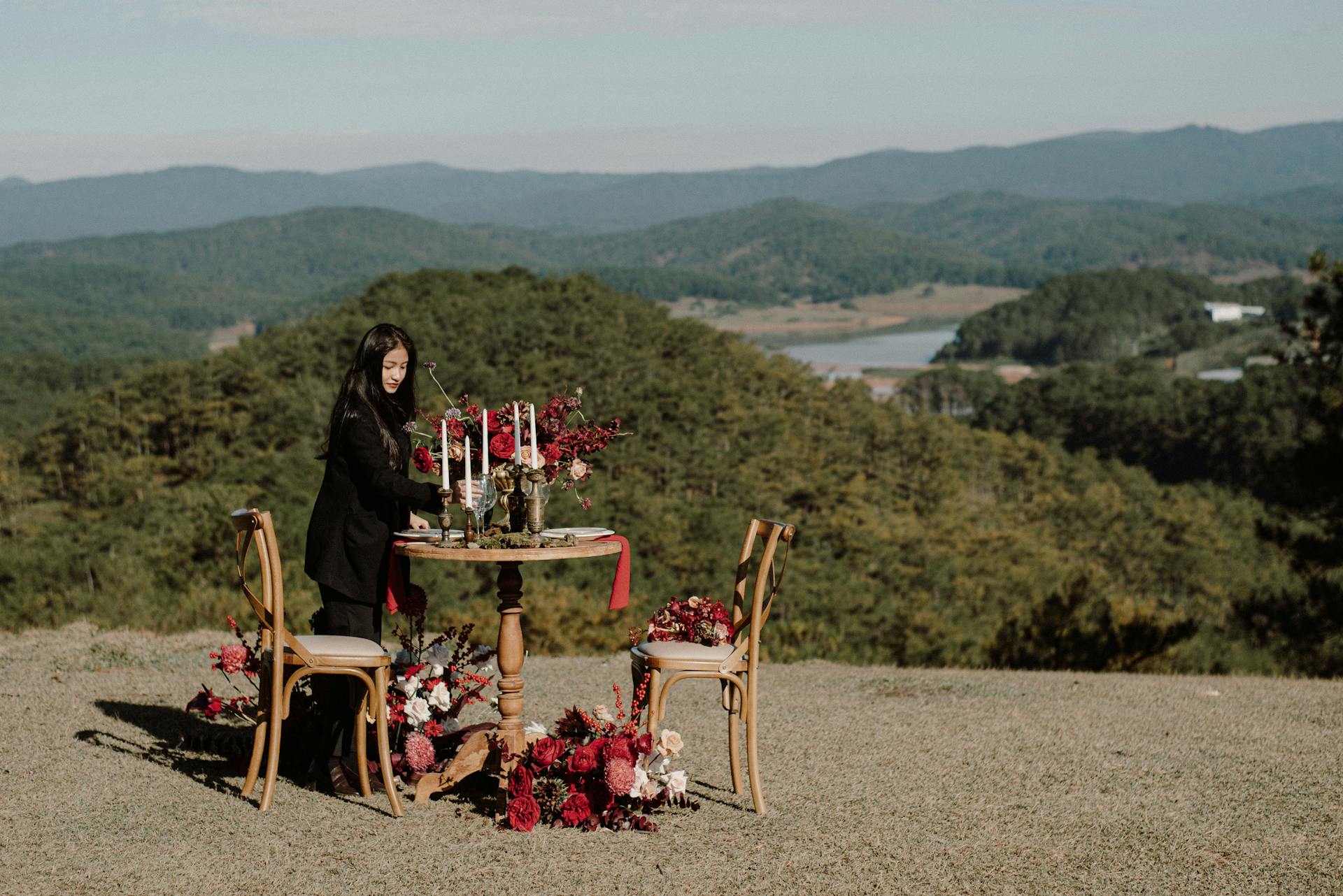 Small round table with floral arrangements and candles, set on a hilltop with scenic green hills and a distant lake. Prop hire, Prop hiring, Prop hire, event stylists Brisbane, brisbane event styling, brisbane event styling, event stylist Brisbane, Brisbane Wedding, Gold Coast Wedding, Floral Styling, Lush & Lavish Events, Brisbane Corporate Styling, Gold Coast Corporate Styling, Brisbane Brand Activation