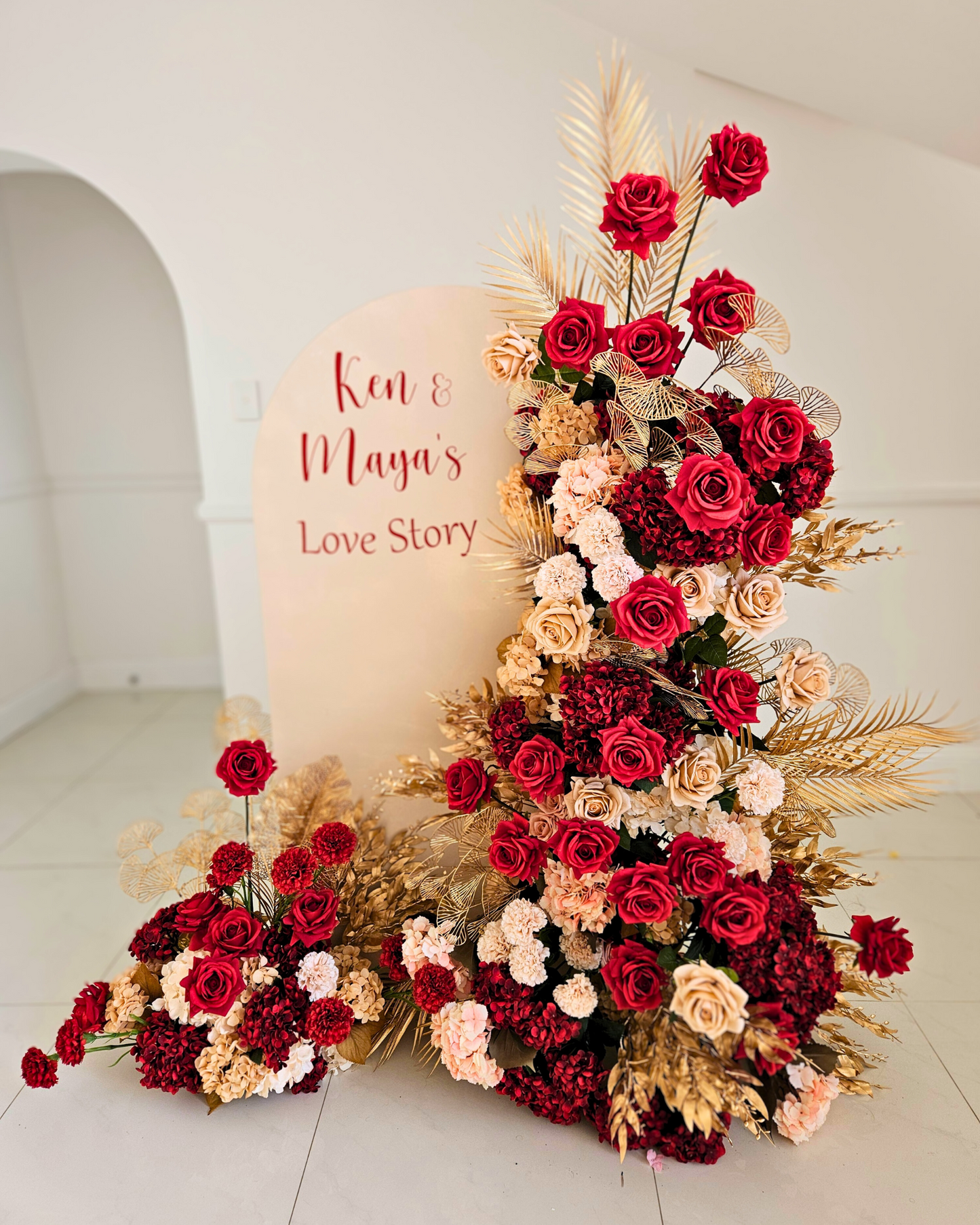 Floral backdrop in red, cream and gold. Signage says "Ken & Maya's Love Story". Balloon backdrop in white, green and gold, with green leaves immersed in the balloons. 5 safari animals and signage saying Wild Two. Prop hire, Prop hiring, Prop hire, event stylists Brisbane, brisbane event styling, brisbane event styling, event stylist Brisbane, Brisbane Wedding, Gold Coast Wedding, Floral Styling, Lush & Lavish Events, Brisbane Corporate Styling, Gold Coast Corporate Styling, Brisbane Brand Activation