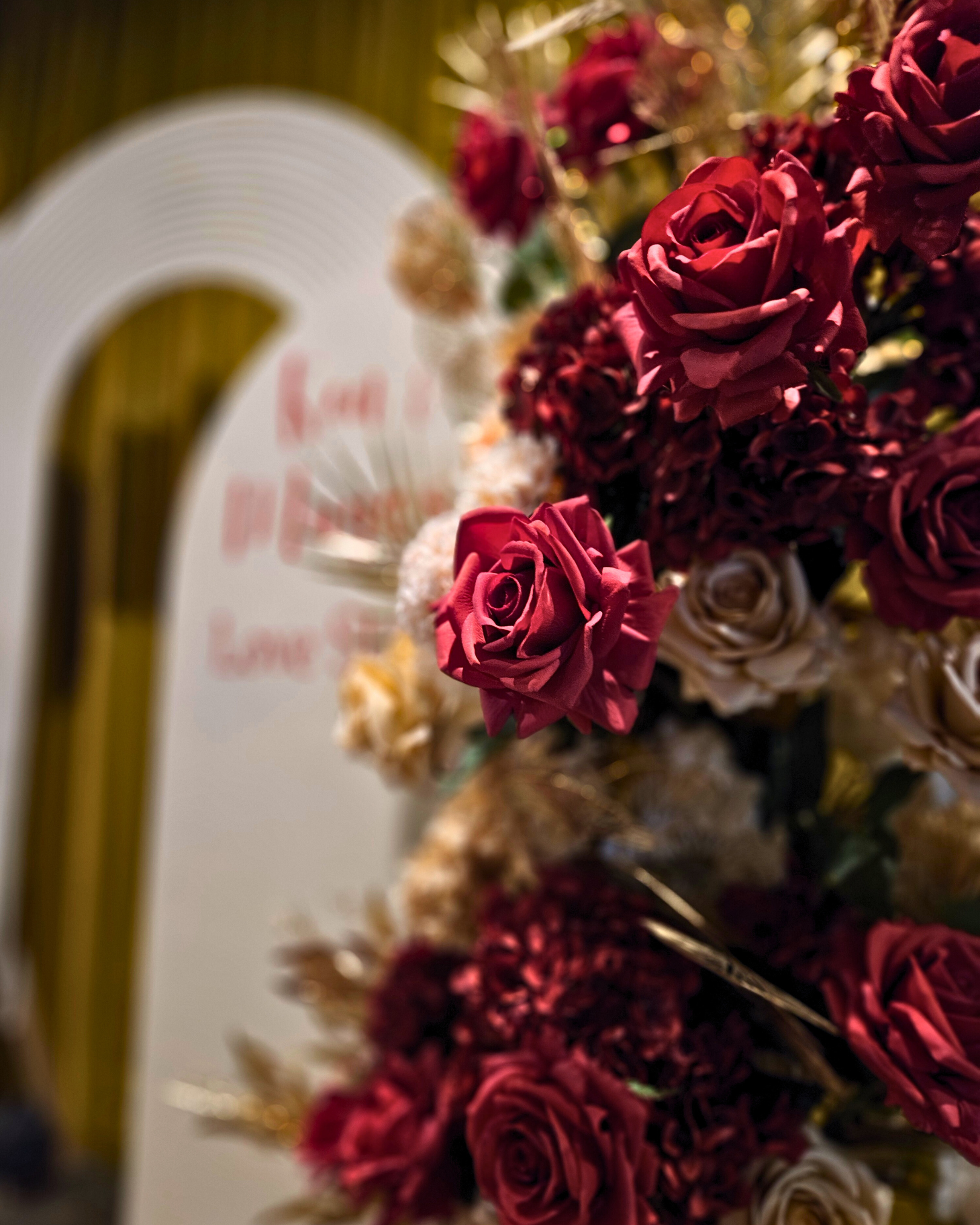 Floral backdrop in red, cream and gold. Signage says "Ken & Maya's Love Story". Balloon backdrop in white, green and gold, with green leaves immersed in the balloons. 5 safari animals and signage saying Wild Two. Prop hire, Prop hiring, Prop hire, event stylists Brisbane, brisbane event styling, brisbane event styling, event stylist Brisbane, Brisbane Wedding, Gold Coast Wedding, Floral Styling, Lush & Lavish Events, Brisbane Corporate Styling, Gold Coast Corporate Styling, Brisbane Brand Activation
