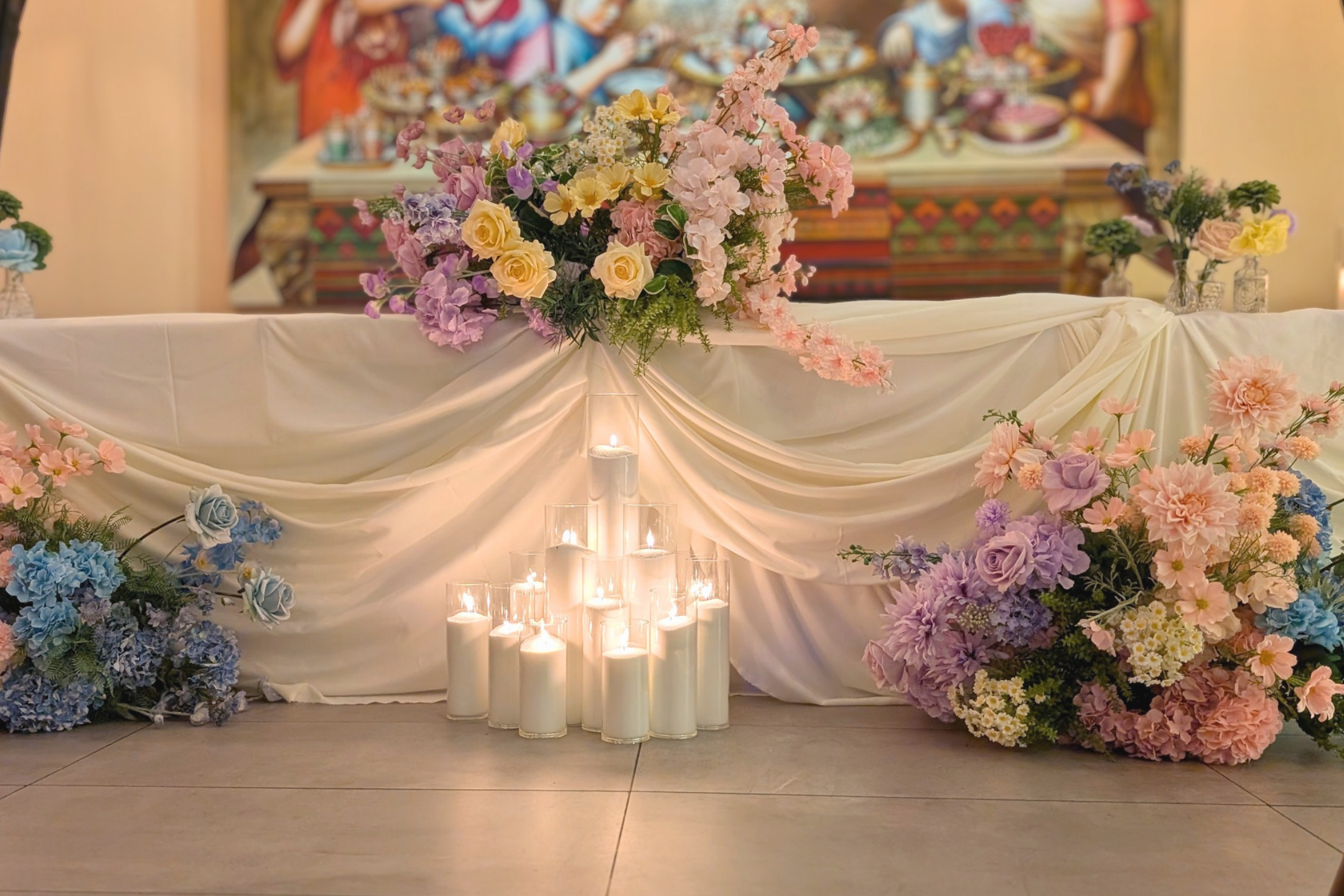 Elegant bridal table styling for Linh and Dineel’s Brisbane wedding reception featuring cream draping, pastel floral arrangements, candlelight and luxury wedding décor by Lush & Lavish Events
