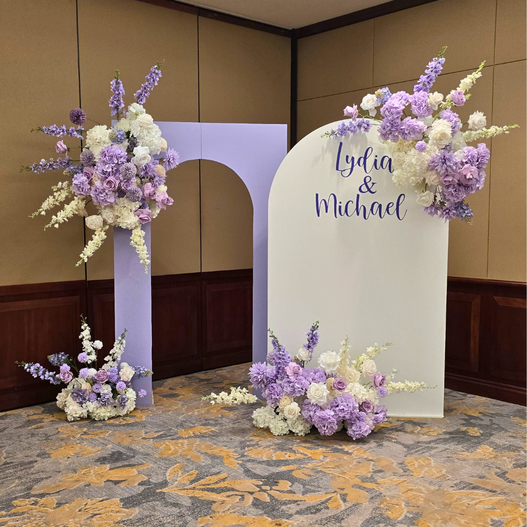Backdrop in white and purple flowers with the signage "Lydia & Michael". Prop hire, Prop hiring, Prop hire, event stylists Brisbane, brisbane event styling, brisbane event styling, event stylist Brisbane, Brisbane Wedding, Gold Coast Wedding, Floral Styling, Lush & Lavish Events, Brisbane Corporate Styling, Gold Coast Corporate Styling, Brisbane Brand Activation, Gold Coast Tablescapes, Brisbane Candle Hire