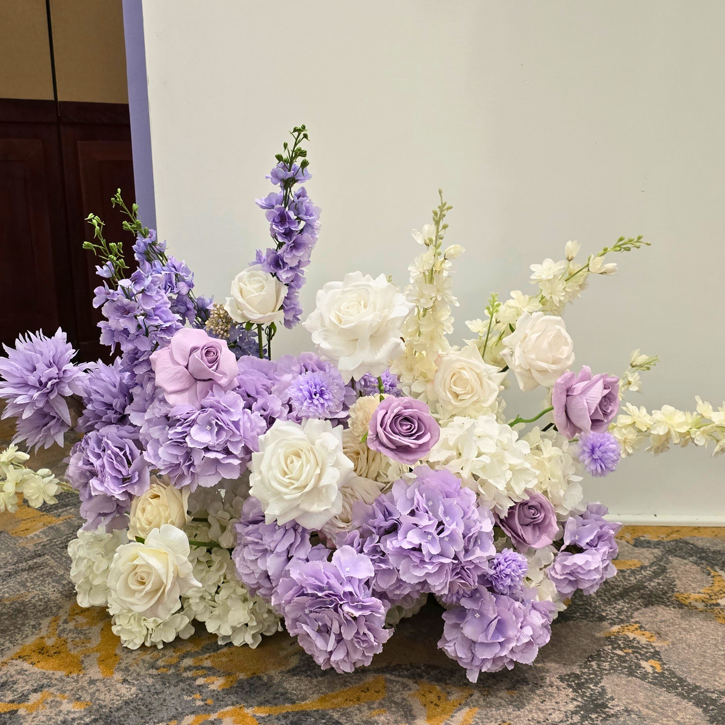 Floral backdrop in purple and white with "Lydia & Michael" on the largest arch. Prop hire, Prop hiring, Prop hire, event stylists Brisbane, brisbane event styling, brisbane event styling, event stylist Brisbane, Brisbane Wedding, Gold Coast Wedding, Floral Styling, Lush & Lavish Events, Brisbane Corporate Styling, Gold Coast Corporate Styling, Brisbane Brand Activation, Gold Coast Tablescapes, Brisbane Candle Hire