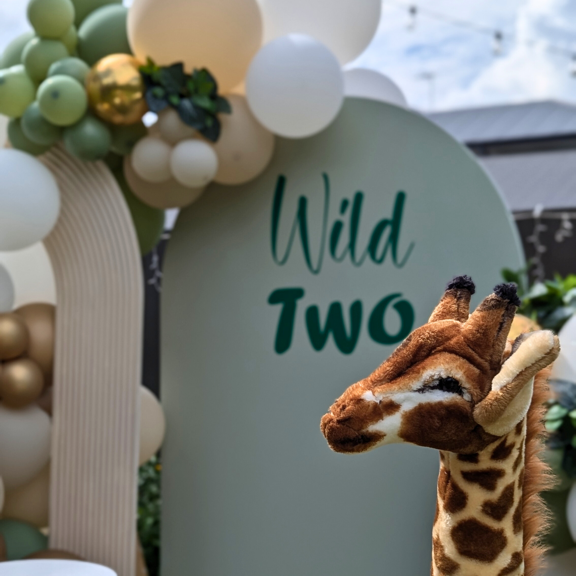 Balloon backdrop in white, green and gold, with green leaves immersed in the balloons. 5 safari animals and signage saying Wild Two. Prop hire, Prop hiring, Prop hire, event stylists Brisbane, brisbane event styling, brisbane event styling, event stylist Brisbane, Brisbane Wedding, Gold Coast Wedding, Floral Styling, Lush & Lavish Events, Brisbane Corporate Styling, Gold Coast Corporate Styling, Brisbane Brand Activation