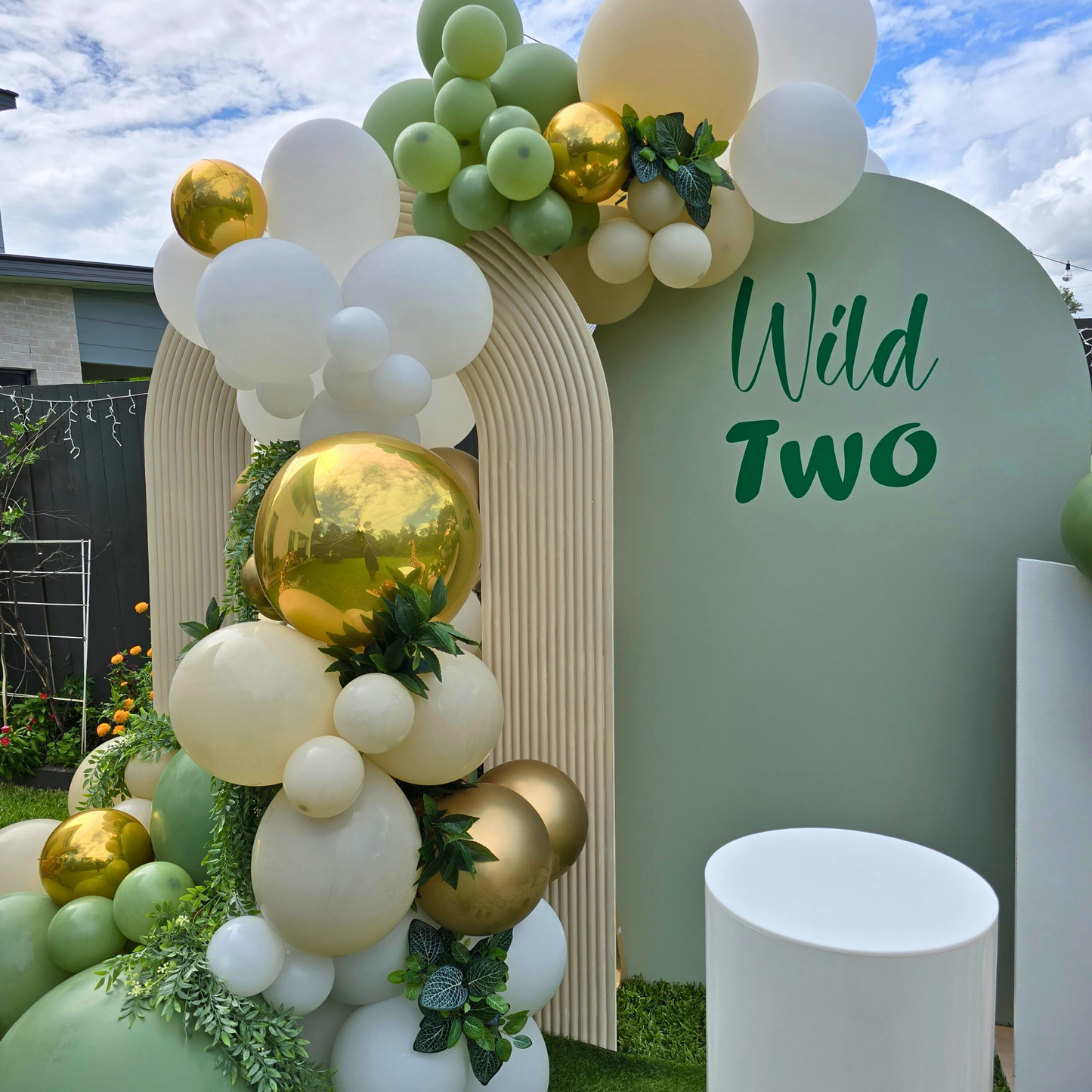 Balloon backdrop in white, green and gold, with green leaves immersed in the balloons. 5 safari animals and signage saying Wild Two. Prop hire, Prop hiring, Prop hire, event stylists Brisbane, brisbane event styling, brisbane event styling, event stylist Brisbane, Brisbane Wedding, Gold Coast Wedding, Floral Styling, Lush & Lavish Events, Brisbane Corporate Styling, Gold Coast Corporate Styling, Brisbane Brand Activation