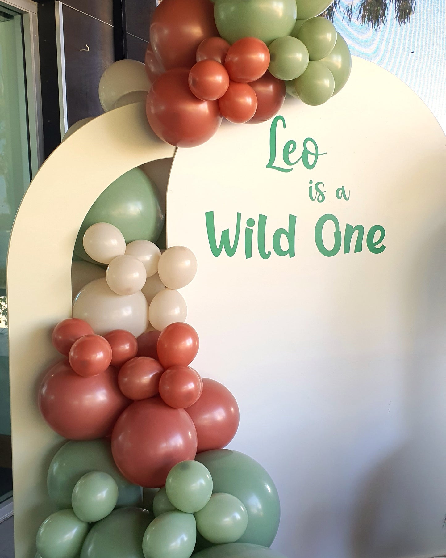 A balloon arch with a sign that reads "Leo is a Wild One." Prop hire, Prop hiring, Prop hire, event stylists Brisbane, brisbane event styling, brisbane event styling, event stylist Brisbane, Brisbane Wedding, Gold Coast Wedding, Floral Styling, Lush & Lavish Events, Brisbane Tablescape, Gold Coast Tablescapes, Brisbane Candle Hire