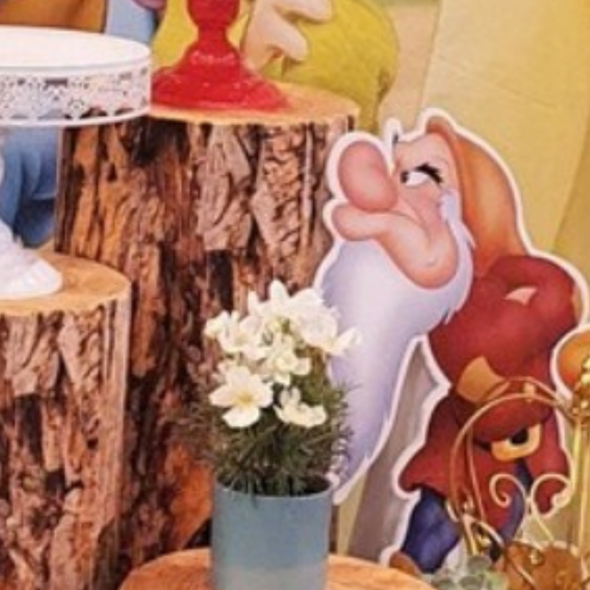Cutout of a dwarf character from Snow White, positioned in front of colorful balloons with a blurred background, ideal for themed parties or events. Prop hire, Prop hiring, Prop hire, event stylists Brisbane, brisbane event styling, brisbane event styling, event stylist Brisbane, Brisbane Wedding, Gold Coast Wedding, Floral Styling, Lush & Lavish Events, Brisbane Tablescape, Gold Coast Tablescapes, Brisbane Candle Hire